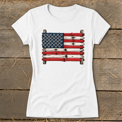 A white short-sleeved t-shirt features a graphic of the American flag made of weathered wooden planks with horseshoes.