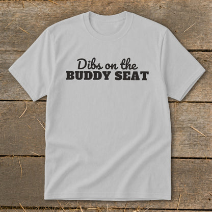 Light grey t-shirt with "Dibs on the BUDDY SEAT" text.