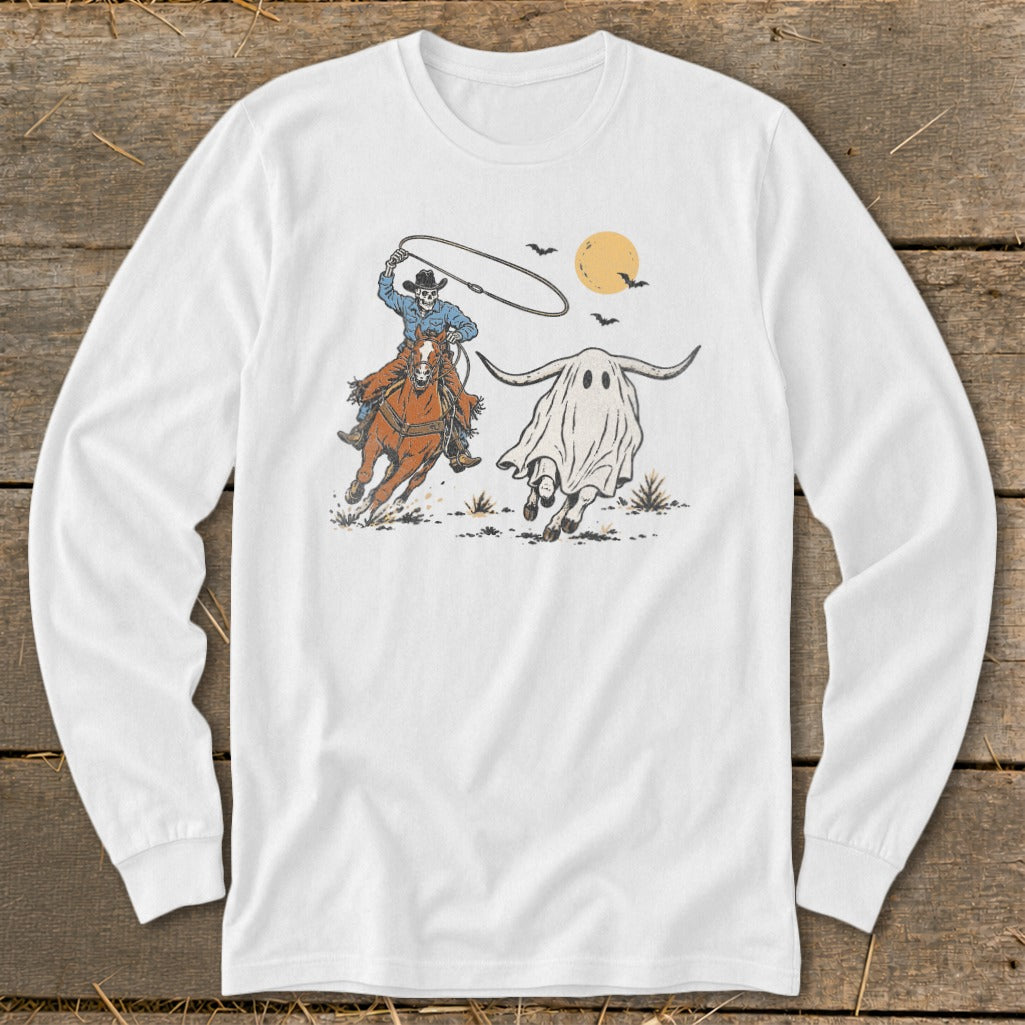 Skeleton cowboy on horseback lassoing a running ghost bull under a full moon.