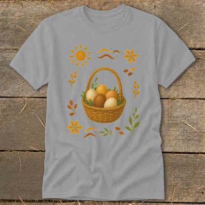 Gray t-shirt with a woven basket filled with brown and cream eggs, surrounded by floral and sun motifs.