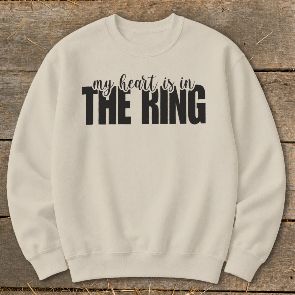 Light tan crewneck sweatshirt with black text that reads "my heart is in THE RING".