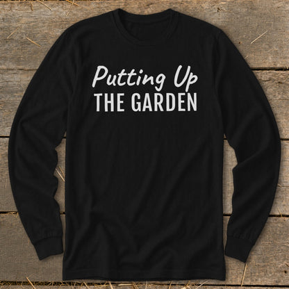 Black long-sleeve shirt with white text reading "Putting Up THE GARDEN".