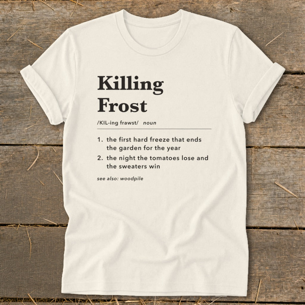 Off-white t-shirt with rolled sleeves laid flat, featuring black text defining "Killing Frost" dictionary-style.