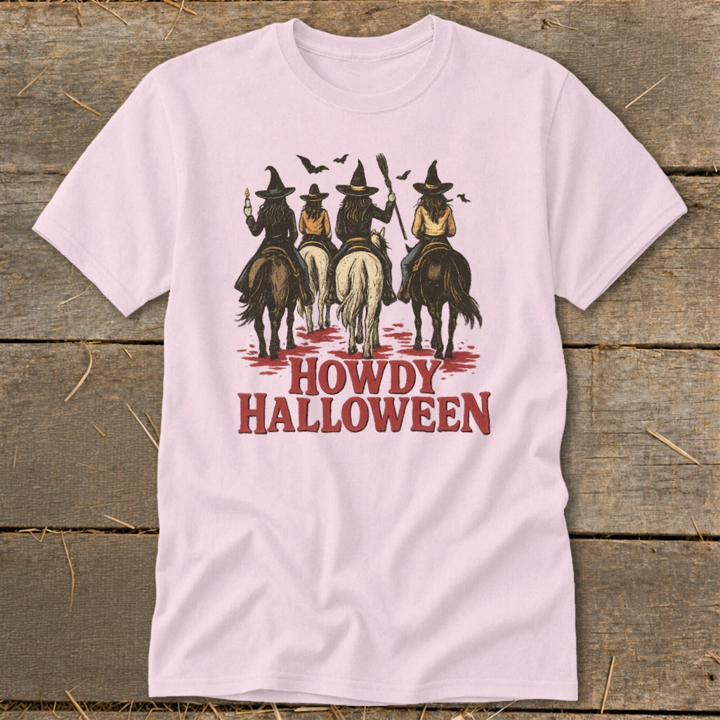 Four witches on horses ride with brooms, bats, and text "Howdy Halloween".