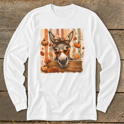 Donkey wearing heart sunglasses and bow, with pumpkins and fall leaves.