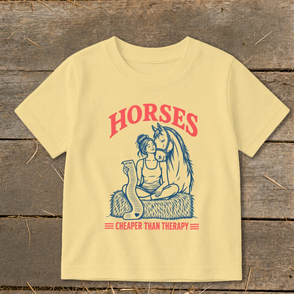 Yellow t-shirt graphic with a woman and horse, text "Horses Cheaper Than Therapy."