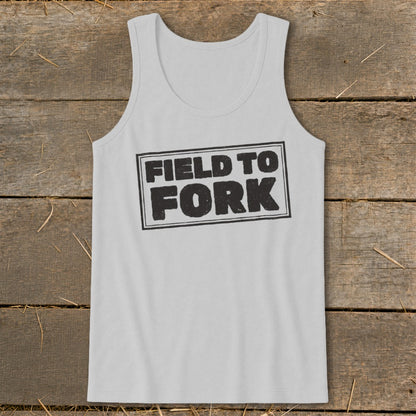 Light gray tank top featuring a black outlined rectangle with the text "FIELD TO FORK" on a wooden background.