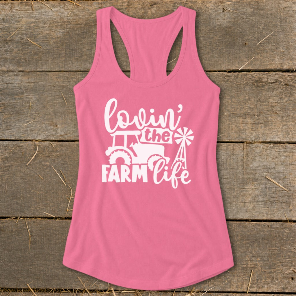 Pink tank top with white graphic of tractor, windmill, and text "lovin' the FARM life".