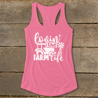 Pink tank top with white graphic of tractor, windmill, and text "lovin' the FARM life".
