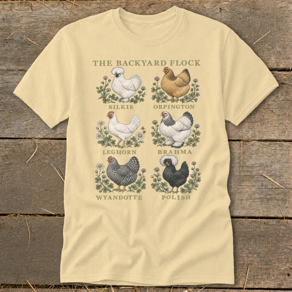 Light yellow t-shirt with "The Backyard Flock" title and six chicken breed illustrations: Silkie, Orpington, Leghorn, Brahma, Wyandotte, Polish.