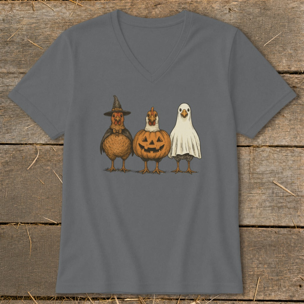 Three chickens dressed as Halloween characters: witch, pumpkin, and ghost.