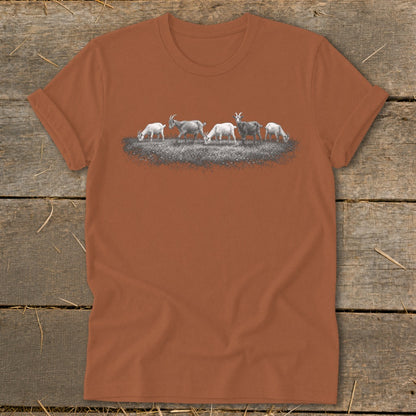 T-shirt with a line of goats grazing in a grassy field.