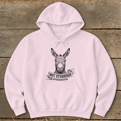 Pink hoodie with a drawing of a donkey and text reading "NOT STUBBORN OPINIONATED".