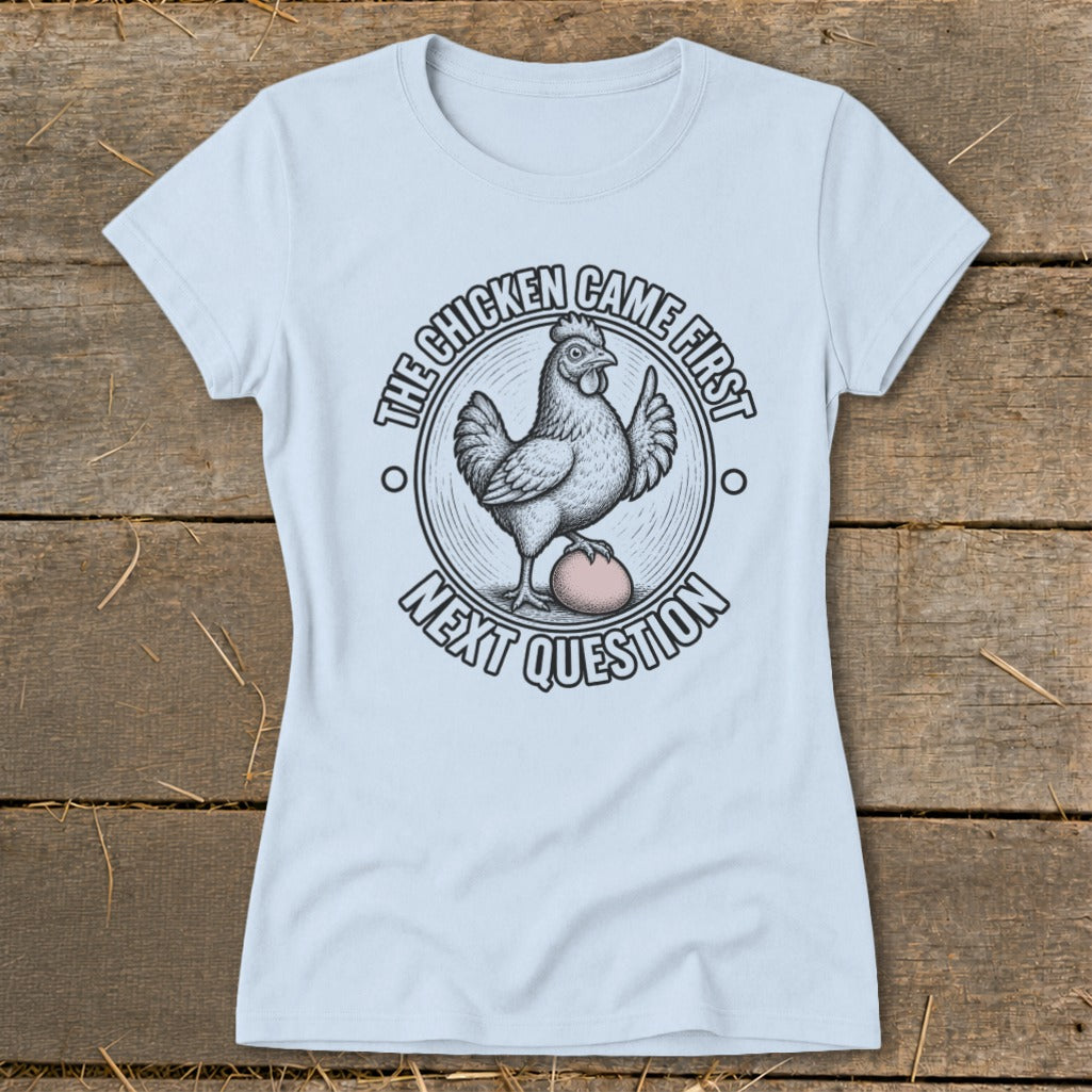 Light blue t-shirt with a circular graphic of a chicken standing on an egg.