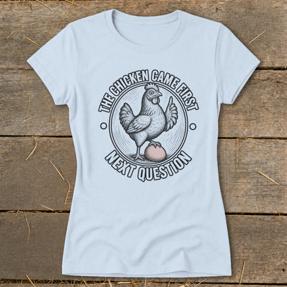 Light blue t-shirt with a circular graphic of a chicken standing on an egg.