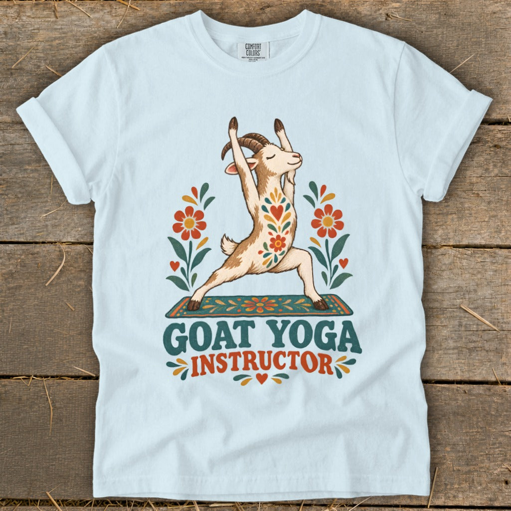 Light blue t-shirt with a goat in yoga pose, surrounded by flowers, text reads "GOAT YOGA INSTRUCTOR".