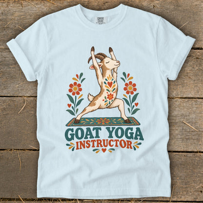 Light blue t-shirt with a goat in yoga pose, surrounded by flowers, text reads "GOAT YOGA INSTRUCTOR".