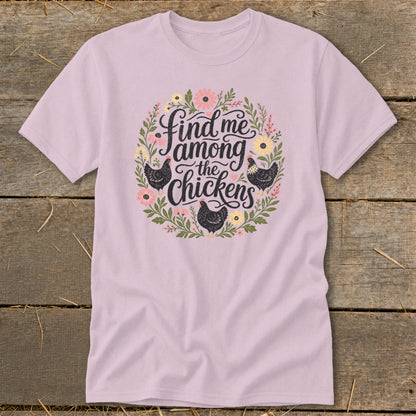 Light pink t-shirt with a floral wreath and chickens graphic reading "Find me among the chickens".