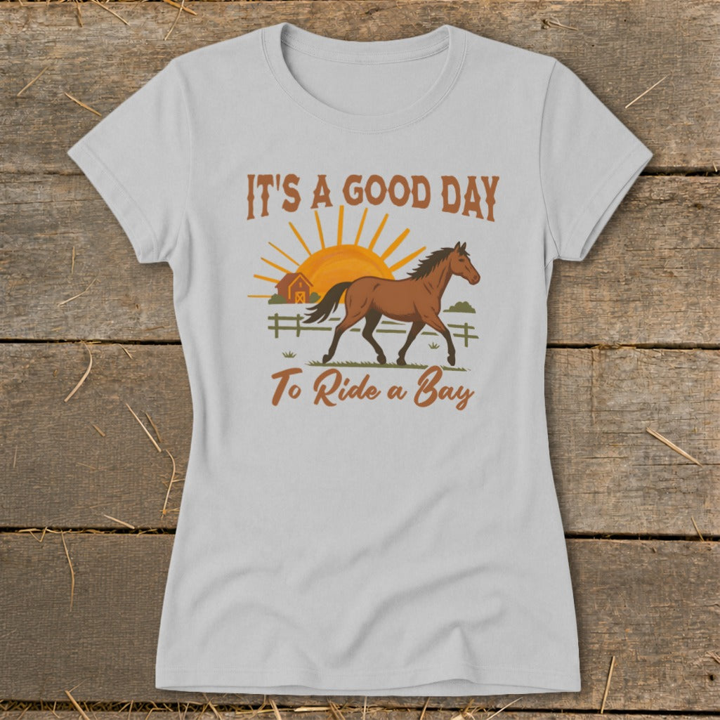 White t-shirt with "It's a Good Day to Ride a Bay" text and horse graphic.
