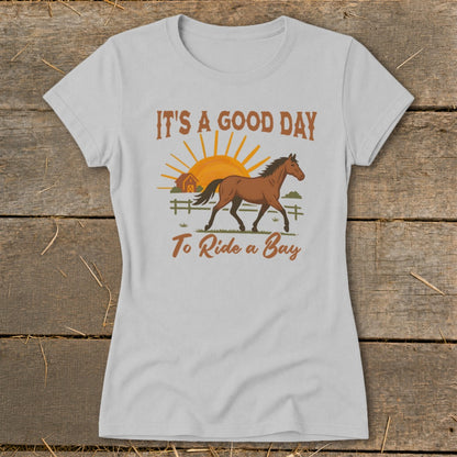 White t-shirt with "It's a Good Day to Ride a Bay" text and horse graphic.