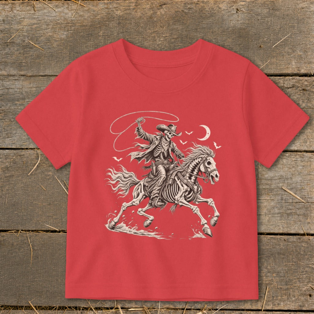 Skeleton cowboy on horseback with lasso, bats, and moon graphic on red shirt.