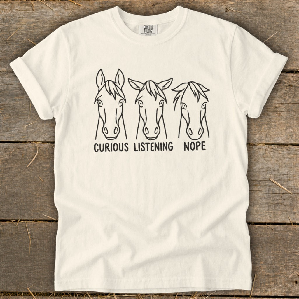 Off-white t-shirt featuring three horse face line drawings with the text curious listening nope underneath.