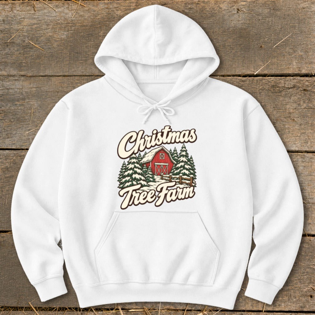 White hoodie with "Christmas Tree Farm" graphic featuring a red barn and pine trees.