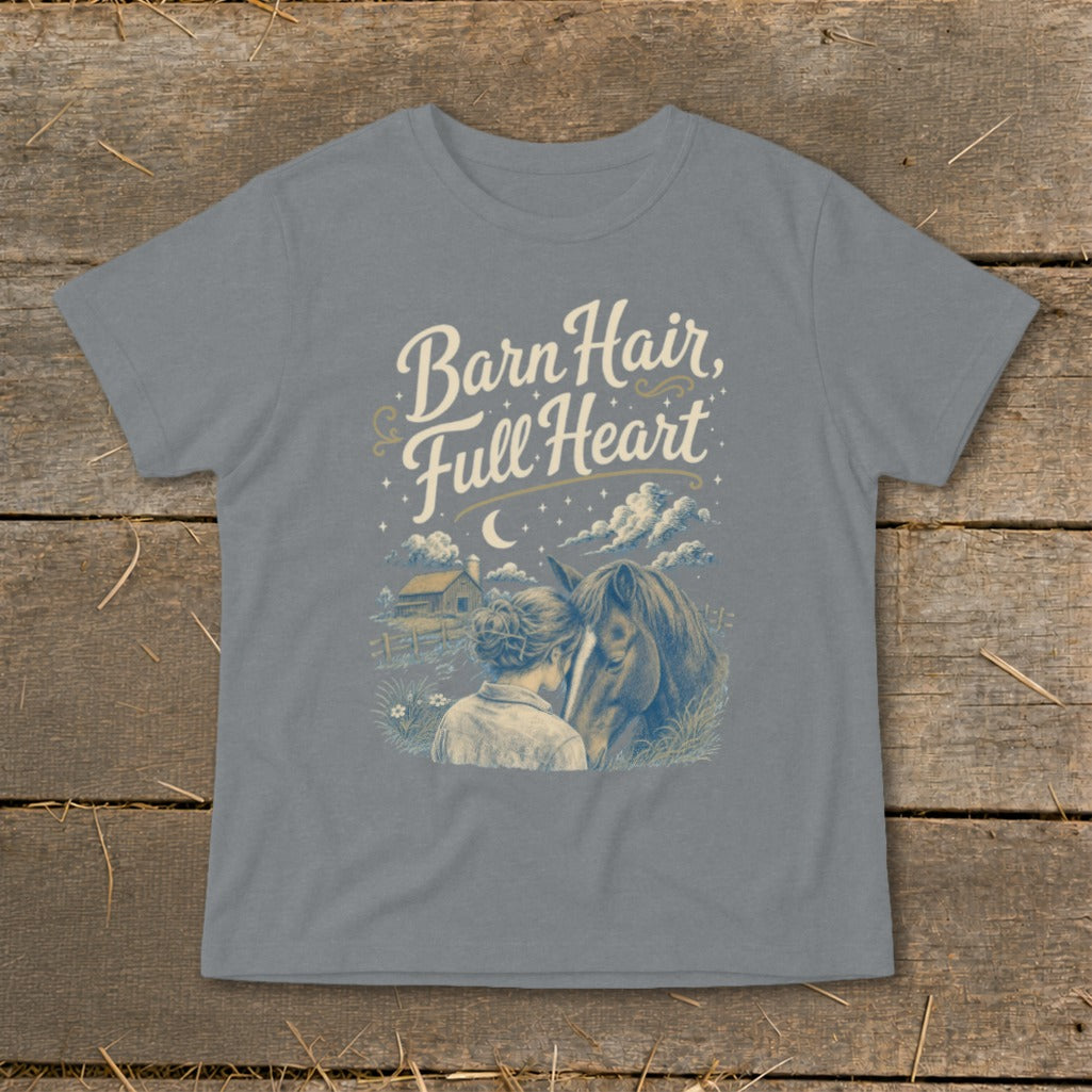 T-shirt graphic with text "Barn Hair, Full Heart" and illustration of a woman and horse.