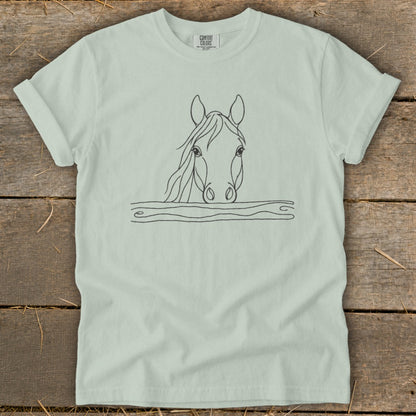 Light green t-shirt with line art of a horse's head peeking over a fence.