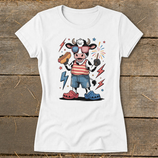 Cartoon cow in sunglasses holding hot dog, wearing red, white, and blue.