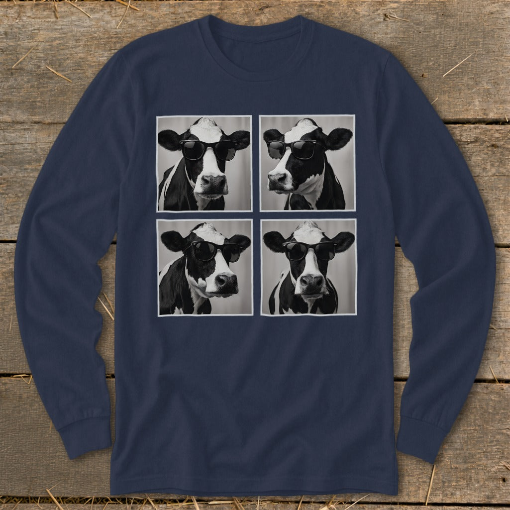 Four black and white cows wearing sunglasses in a grid on a navy shirt.