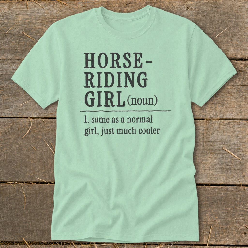 Light blue t-shirt with "Horse-Riding Girl (noun)" definition.