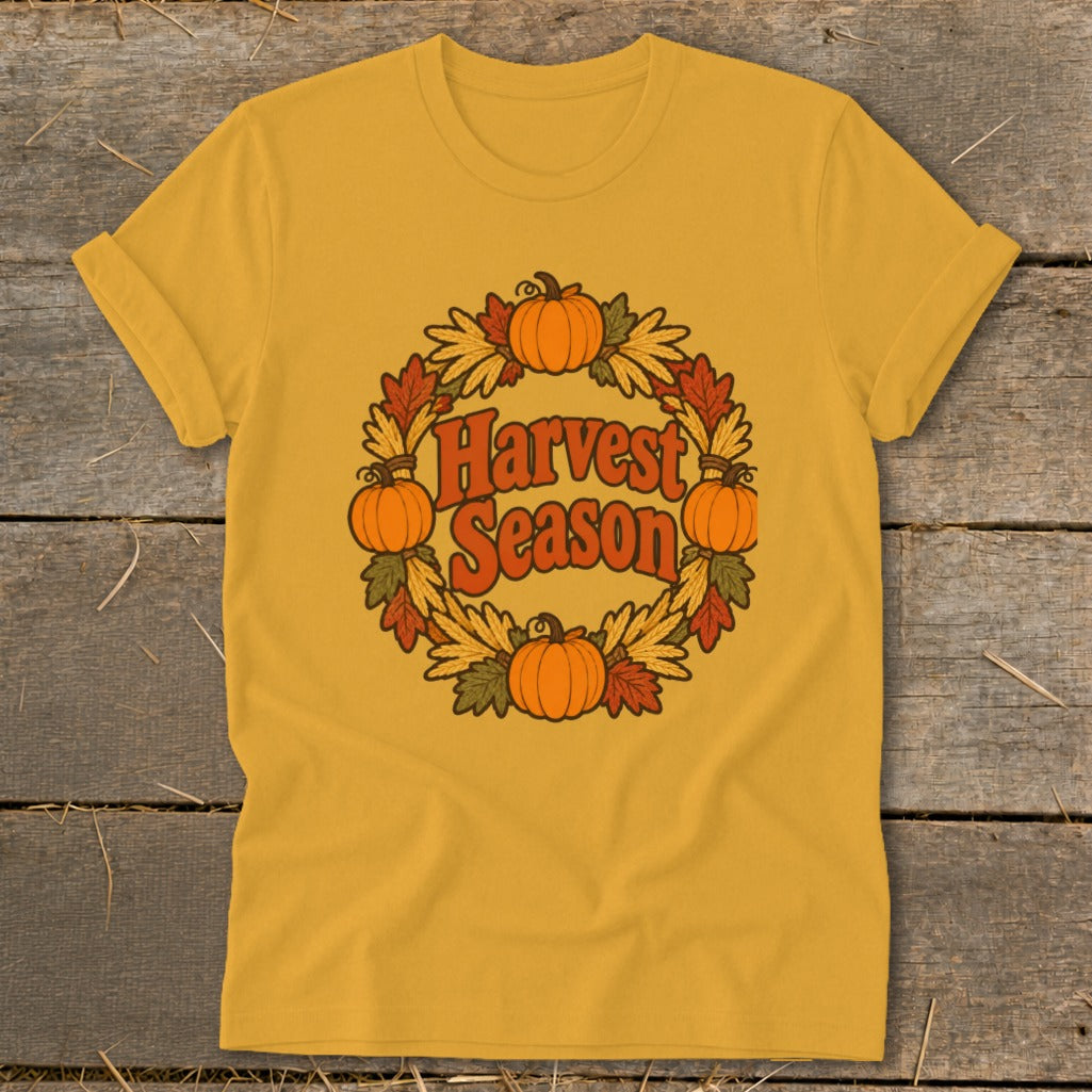Yellow t-shirt with "Harvest Season" in a circular design of pumpkins and fall leaves.