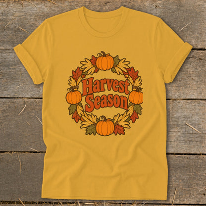 Yellow t-shirt with "Harvest Season" in a circular design of pumpkins and fall leaves.
