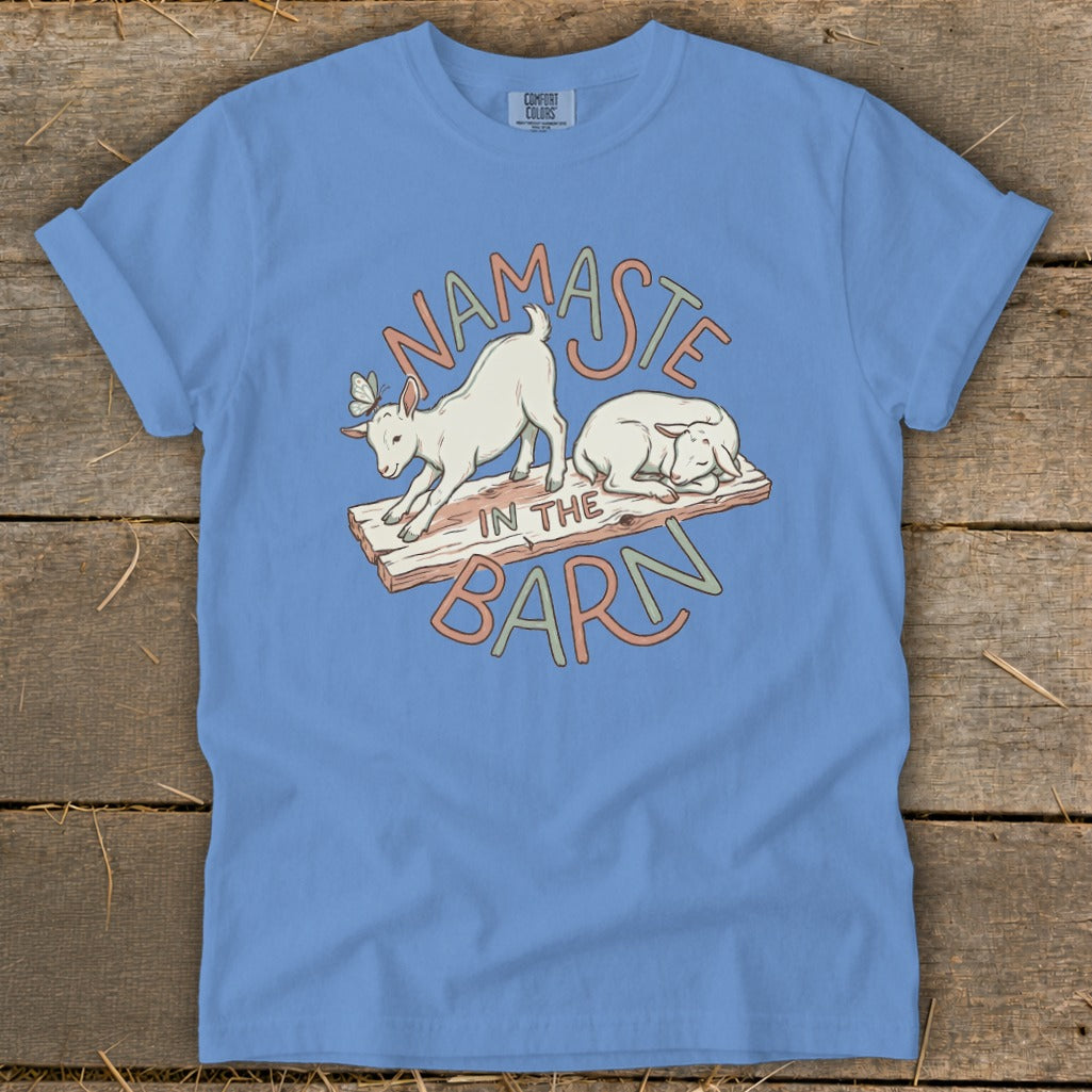 Blue t-shirt with goats and text "Namaste in the Barn".