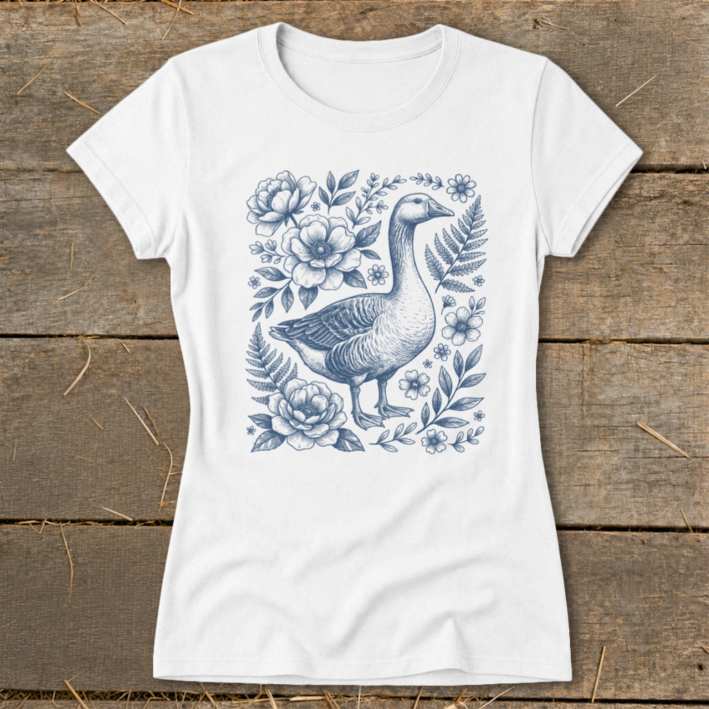 White t-shirt with a blue goose and floral botanical illustration.