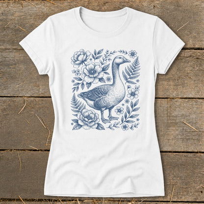 White t-shirt with a blue goose and floral botanical illustration.