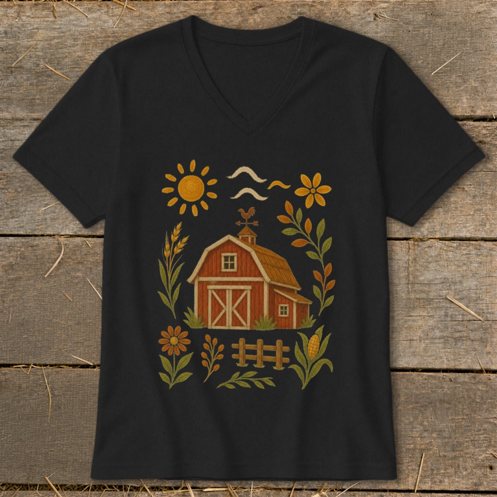 Black t-shirt with a red barn illustration surrounded by farm-themed elements and floral accents.