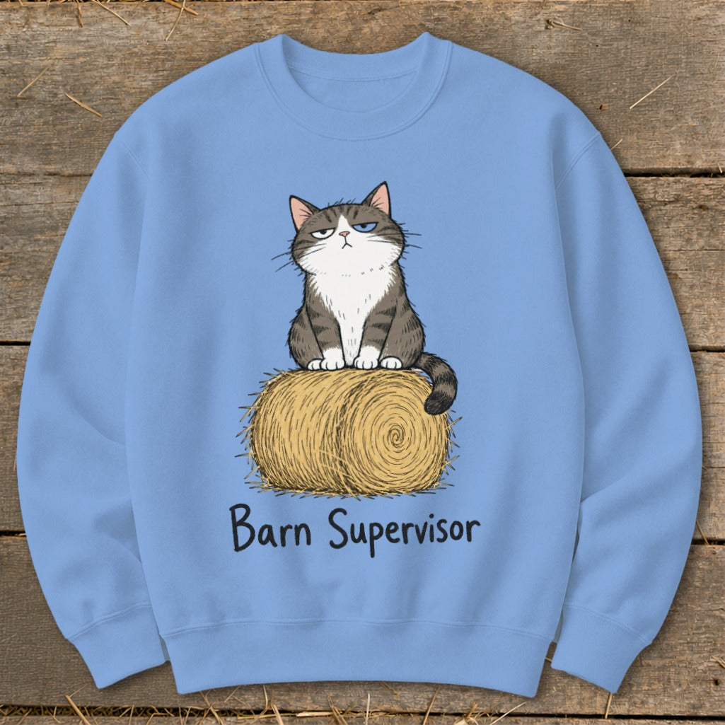 Light blue sweatshirt with a cartoon cat sitting on a hay bale and text "Barn Supervisor".