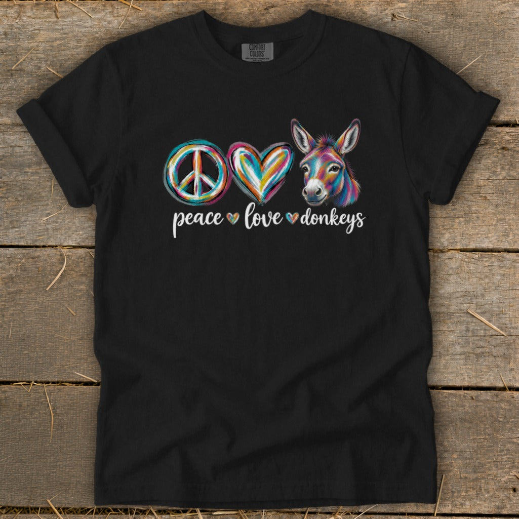 Black t-shirt with colorful peace, heart, and donkey graphic and text.