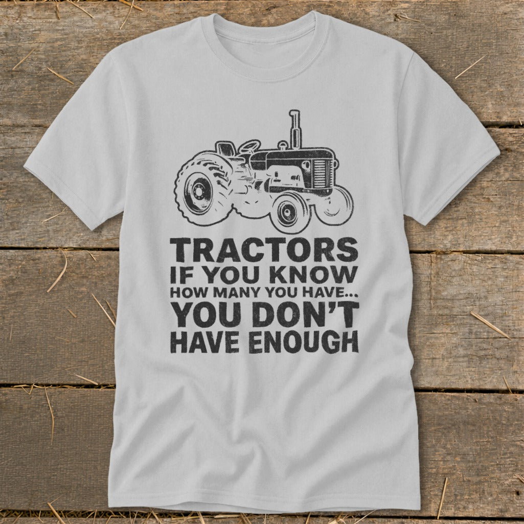 T-shirt with a drawing of a tractor and the text "Tractors if you know how many you have... you don't have enough."