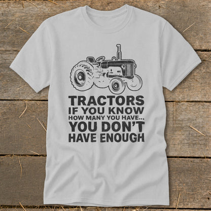 T-shirt with a drawing of a tractor and the text "Tractors if you know how many you have... you don't have enough."