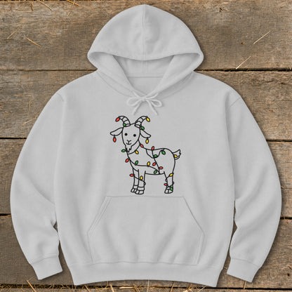 White hoodie with a cartoon goat wrapped in colorful Christmas lights design.