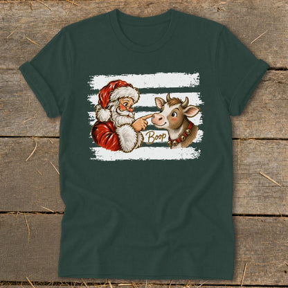 Santa boops a cow with the word "Boop" on a dark green t-shirt.