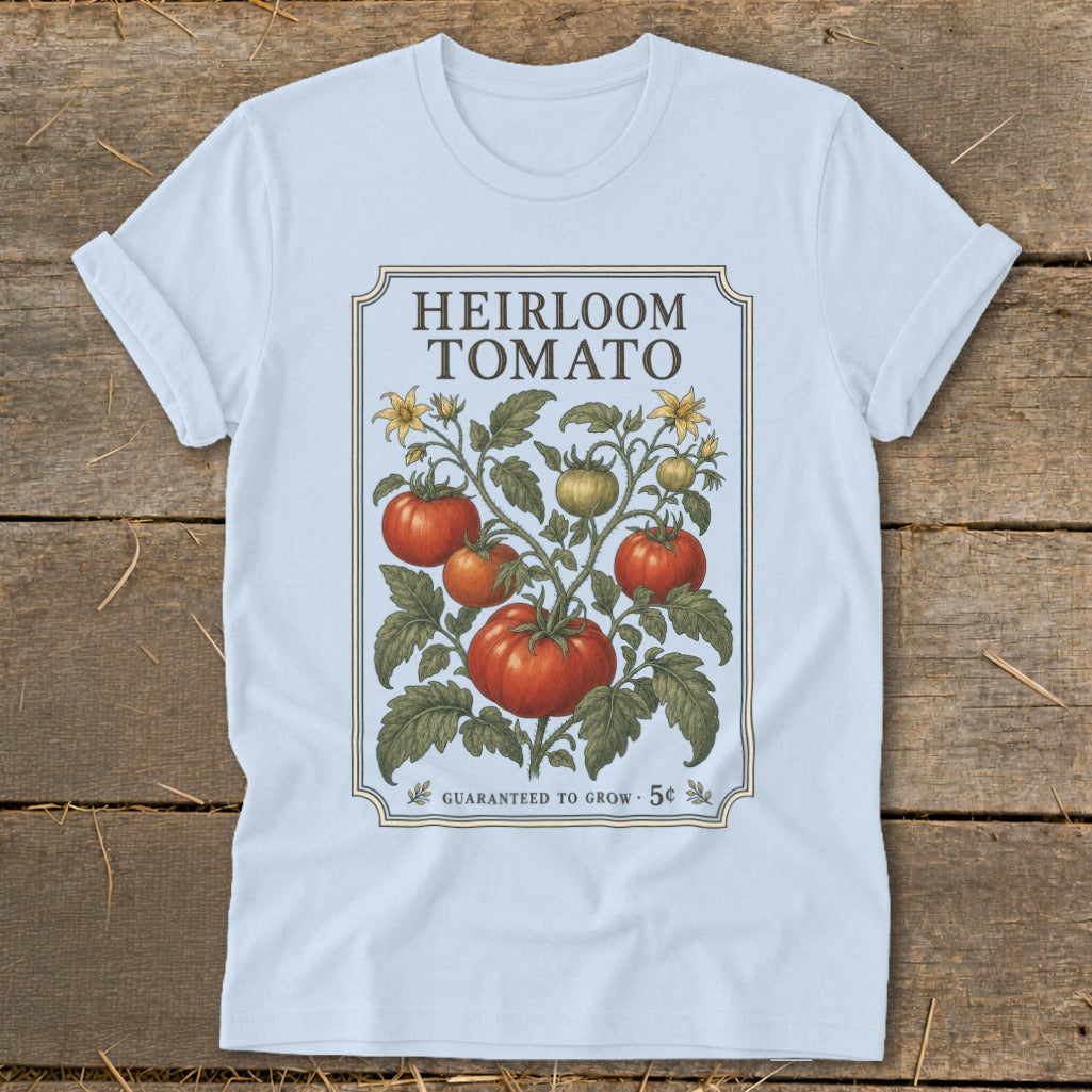 Light blue t-shirt with an "Heirloom Tomato" graphic and a vintage tomato plant illustration.