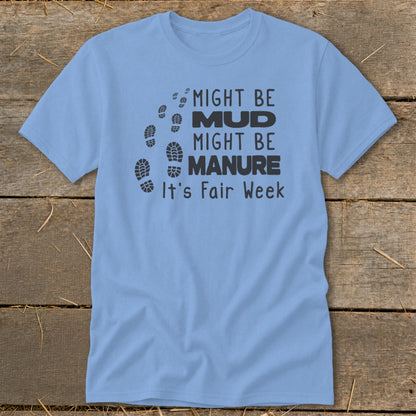 Light blue t-shirt with black text and footprints saying "Might be Mud, Might be Manure, It's Fair Week."