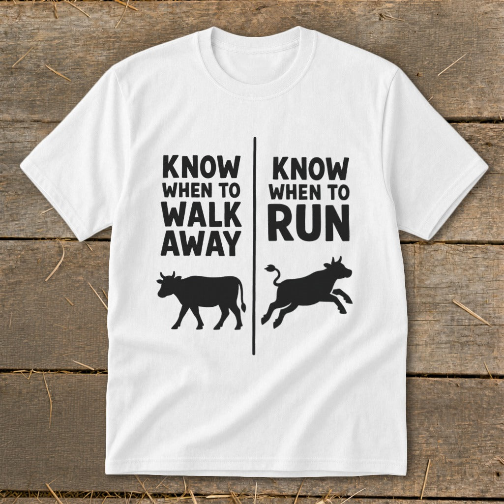 White t-shirt with black text and cow graphics: "Know when to walk away" and "Know when to run".