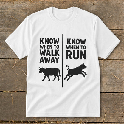 White t-shirt with black text and cow graphics: "Know when to walk away" and "Know when to run".
