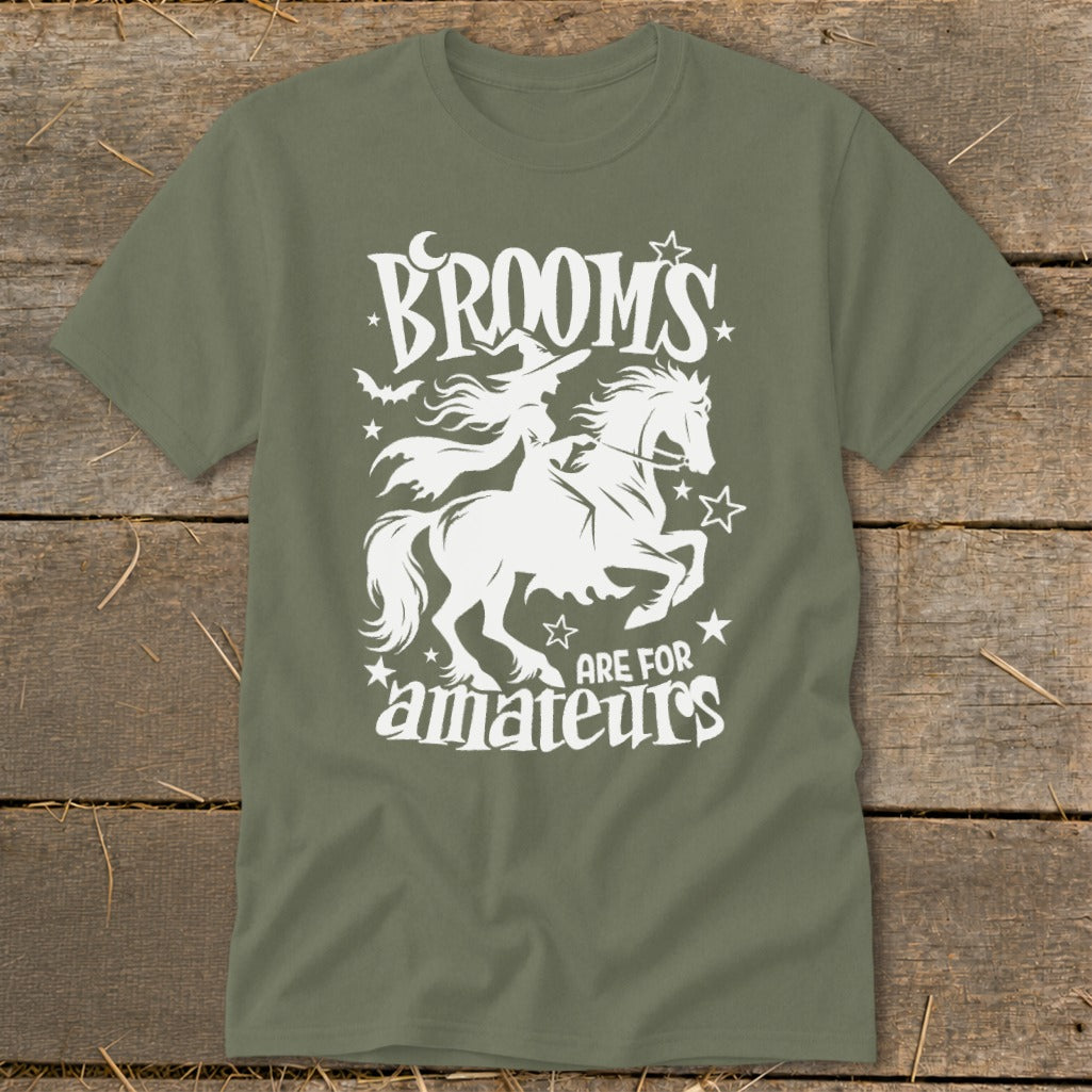 Green t-shirt with white graphic of witch on horse, text "Brooms are for amateurs."