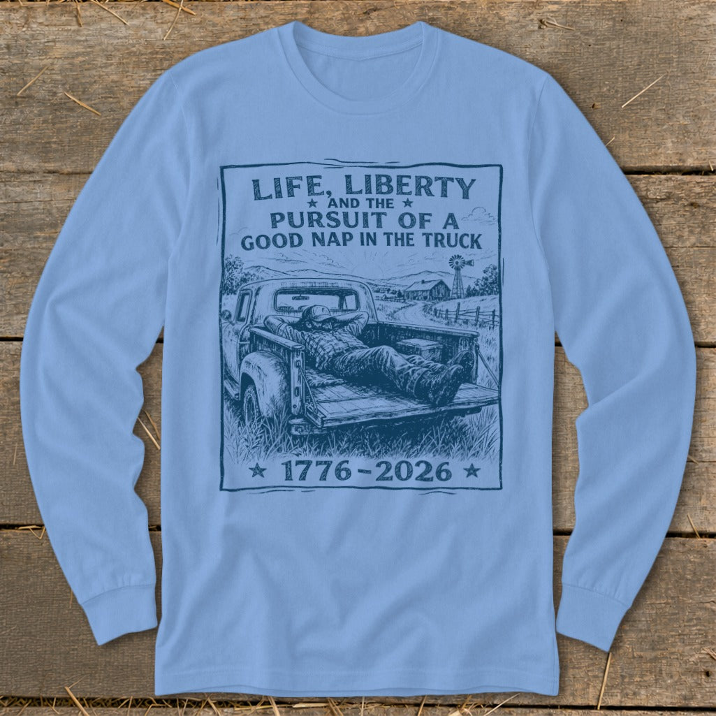 Light blue long sleeve shirt with a graphic of a man napping in a truck.